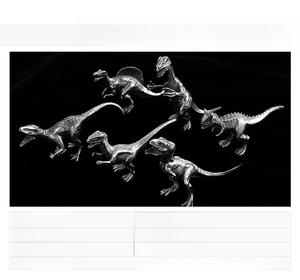 Detailed view of six miniature stainless steel dinosaur models with metallic textures