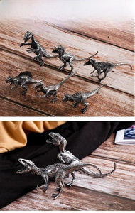 Detailed view of vintage metal dinosaur models with intricate textures and silver-black finish