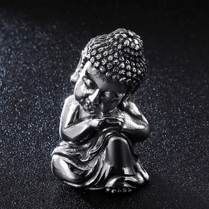 Polished stainless steel Buddha figurine ornament on a professional dark background