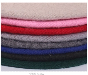 Detail view of multi-color wool knit berets showing soft texture and premium stitching