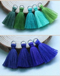 Detail of 3.5cm cotton tassels with silver metal rings in green and blue shades