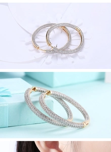 Macro detail of large gold hoop earrings with full pavé cubic zirconia setting