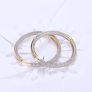 Elegant gold hoop earrings with white zircon pave setting on a clean white background