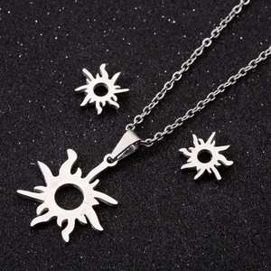 Silver sunflower jewelry set including necklace and earrings on a black glitter background