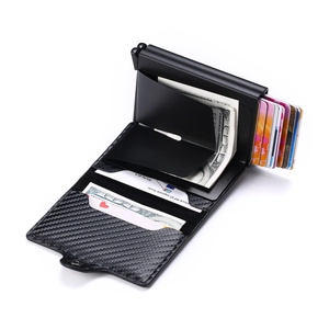 Detail showing carbon fiber texture and automatic pop-up aluminum card holder for RFID wallet