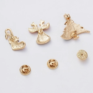 Detail view of gold-plated Christmas brooch backs with safety pins and butterfly clutches
