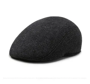 Side view of dark gray elderly men's winter flat cap with fine woven wool texture