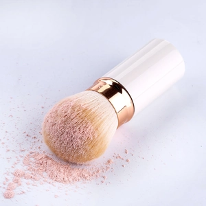Retractable large powder brush with rose gold ferrule and soft dual-tone bristles