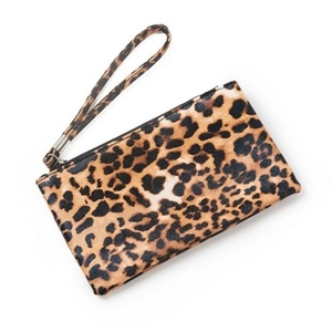 Close-up of stylish leopard print clutch bag with zipper closure and matching wristlet strap