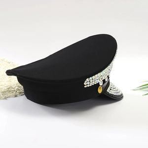 Close-up of sparkling iridescent rhinestones and gold buckles on a black flat-top military hat