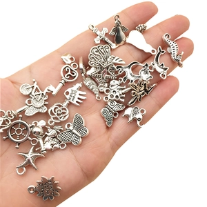 Mix of 100 silver Tibetan alloy charms including butterflies and keys for DIY jewelry