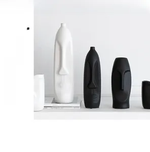 Minimalist matte black and white ceramic face vases with modern abstract art design