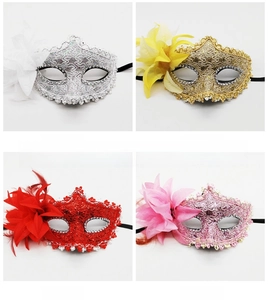 Detail of four colorful lace masks with feathers and silk flowers for masquerade parties
