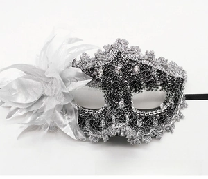 Detail of Venetian lace mask with silver rose, sequins and black elastic strap for parties