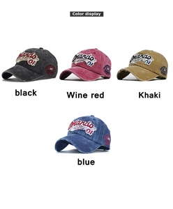 Detail of embroidered vintage washed baseball caps in black, wine red, khaki and blue
