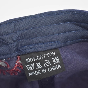 Detailed view of the wash care label on a 100% cotton washed denim baseball cap
