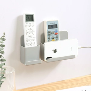 Wall-mounted grey ABS organizer with charging port for remote control and phone