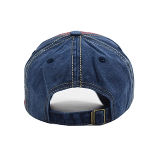 Detail view of cotton baseball cap back with adjustable brass buckle and vent holes