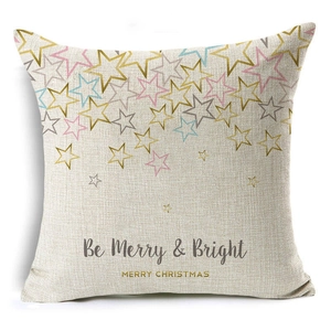 Detail of linen pillow cover with festive 'Be Merry & Bright' lettering and stars