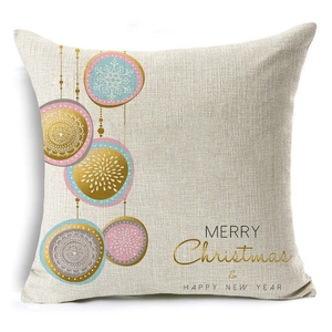 Detail of Christmas linen pillowcase showing festive gold baubles and holiday text