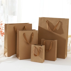 Detailed view of brown kraft paper gift bags with fabric handles in various sizes