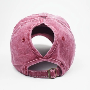 Detail view of washed cotton baseball cap with ponytail hole and metal buckle closure