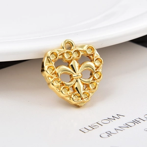 Golden heart pendant with hollow fleur-de-lis design on white background