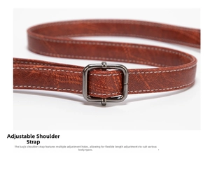 Detail of adjustable brown leather shoulder strap with vintage metal buckle and stitching