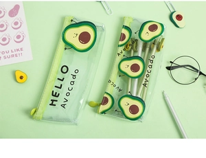 Close-up of clear PVC avocado pencil cases with green zippers and stationery accessories
