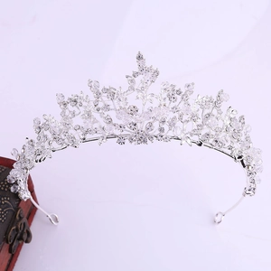 Close-up of handmade bridal tiara with sparkling crystal flowers and silver alloy frame