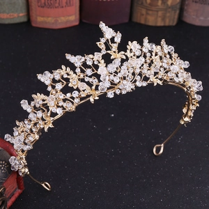 Close-up of golden bridal crown with sparkling crystal rhinestones and floral alloy details