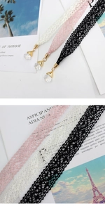 Detailed close-up of lace choker necklace with crystal pendant and gold metal clasp