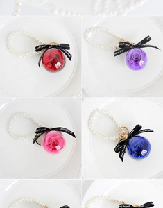 Collage of preserved rose ball keychains in red, purple, pink and blue with pearl straps
