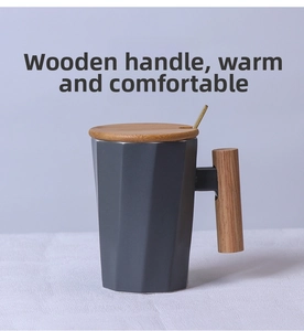 Detail of grey ceramic mug with faceted texture and a natural wooden handle and lid