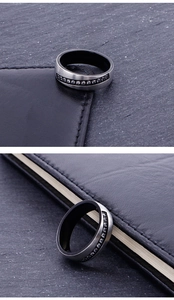 Detail of brushed silver and matte black titanium ring with inlaid cubic zirconia