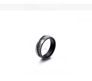 Detail of 6mm black zircon inlaid stainless steel ring with brushed finish texture