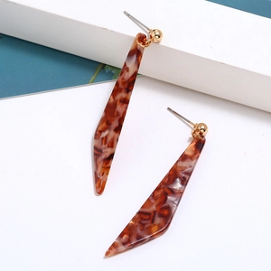 Detail view of long acetic acid drop earrings with brown marble texture and gold studs