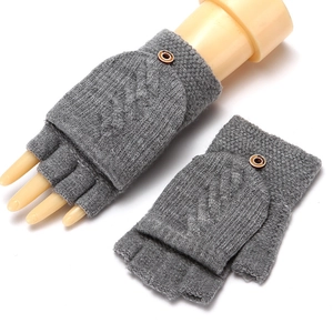 Detail of grey cable knit fingerless gloves with a buttoned convertible mitten cover