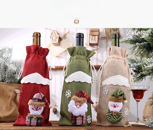 Detail of burlap Christmas wine bottle covers featuring plush Santa and Snowman designs