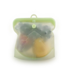 Macro detail of silicone food storage bag featuring green top seal and date tracker dial