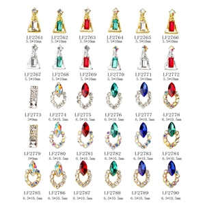 Flat lay of 30 assorted K9 colorful nail art crystals with gold and silver alloy frames