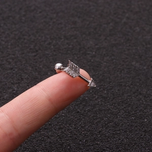 Stainless steel arrow stud earring with micro-set zircon stones shown on hand