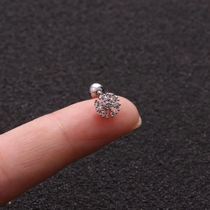 Detailed macro shot of a silver snowflake screw back earring with sparkling zircons