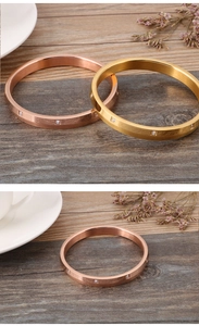 Close-up of gold and rose gold brushed steel bracelets with tiny cubic zirconia stones