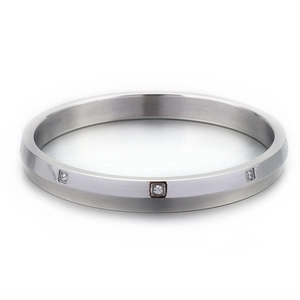 Minimalist silver stainless steel bracelet with three square set diamonds on a matte surface