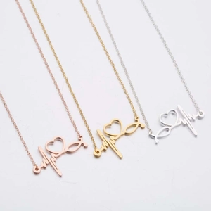 Minimalist stethoscope heart necklaces in rose gold, gold, and silver finishes