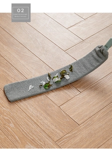 Detail of microfiber gap duster cleaning dust and debris on light herringbone wood floor