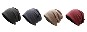 Row of four knitted beanies in dark grey, blue, khaki, and burgundy with rolled edges
