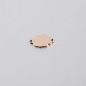 Macro shot of rose gold cloud-shaped connector with dual rings for jewelry making
