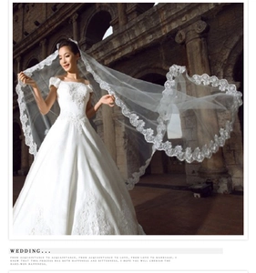 Dramatic view of a 3-meter white lace wedding veil on a model in Roman ruins